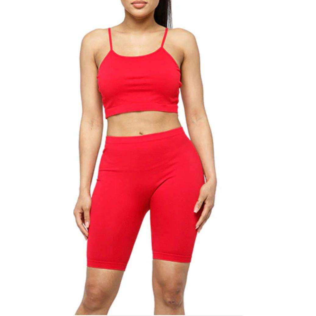 Woman wearing red seamless crop tank and biker short set activewear
