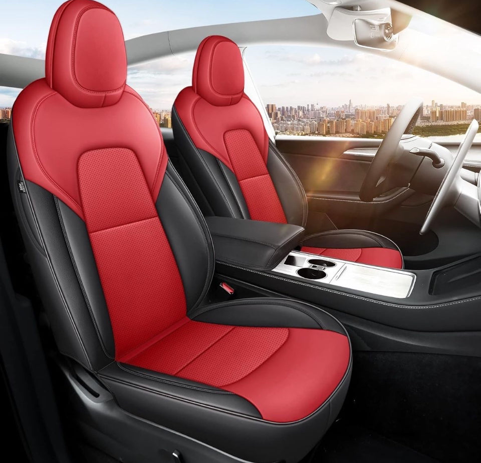Red and black nappa leather Tesla Model Y seat covers installed on front car seats with city view background