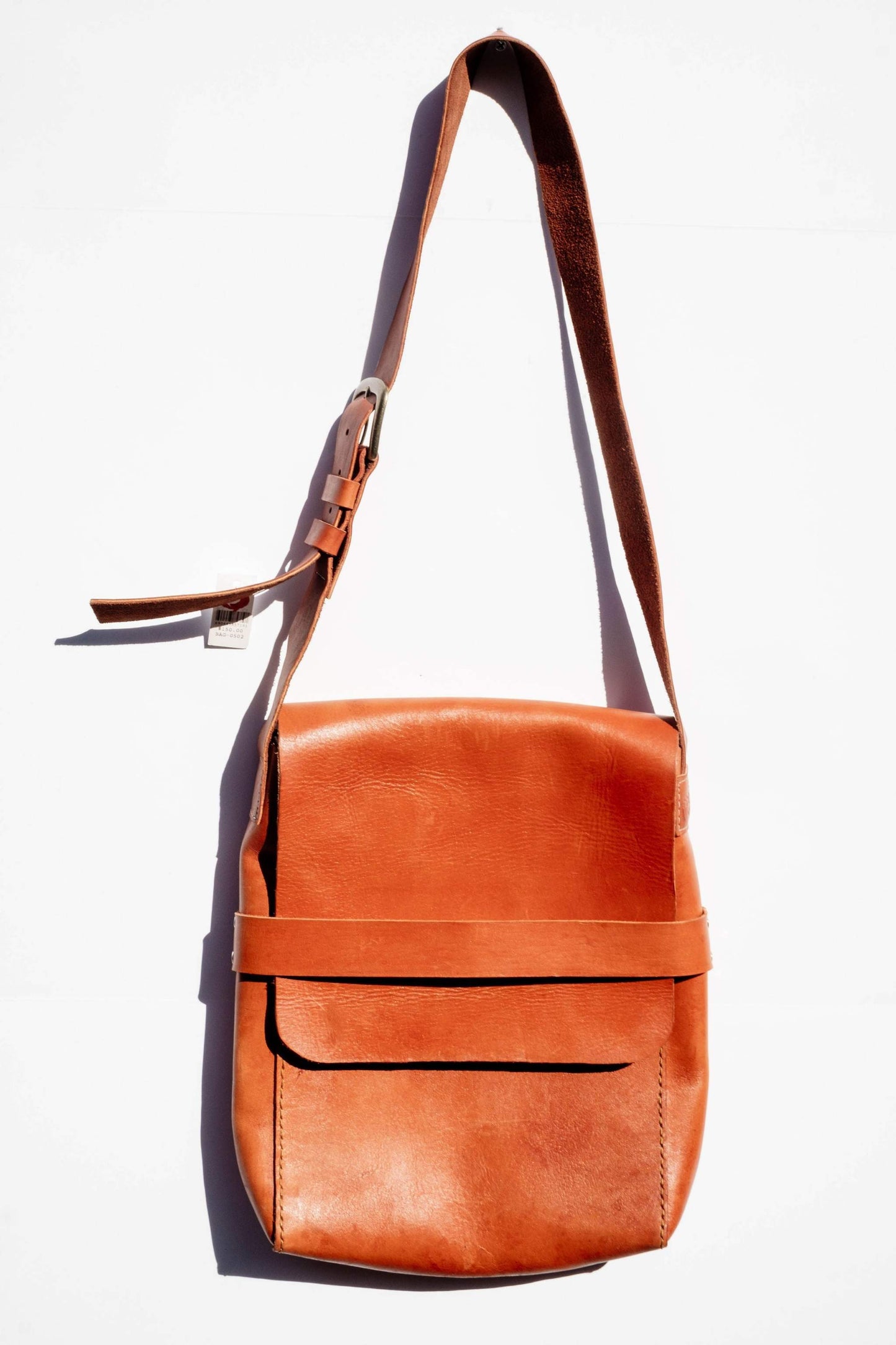 Handcrafted leather messenger bag with adjustable strap and front pocket, perfect for everyday use