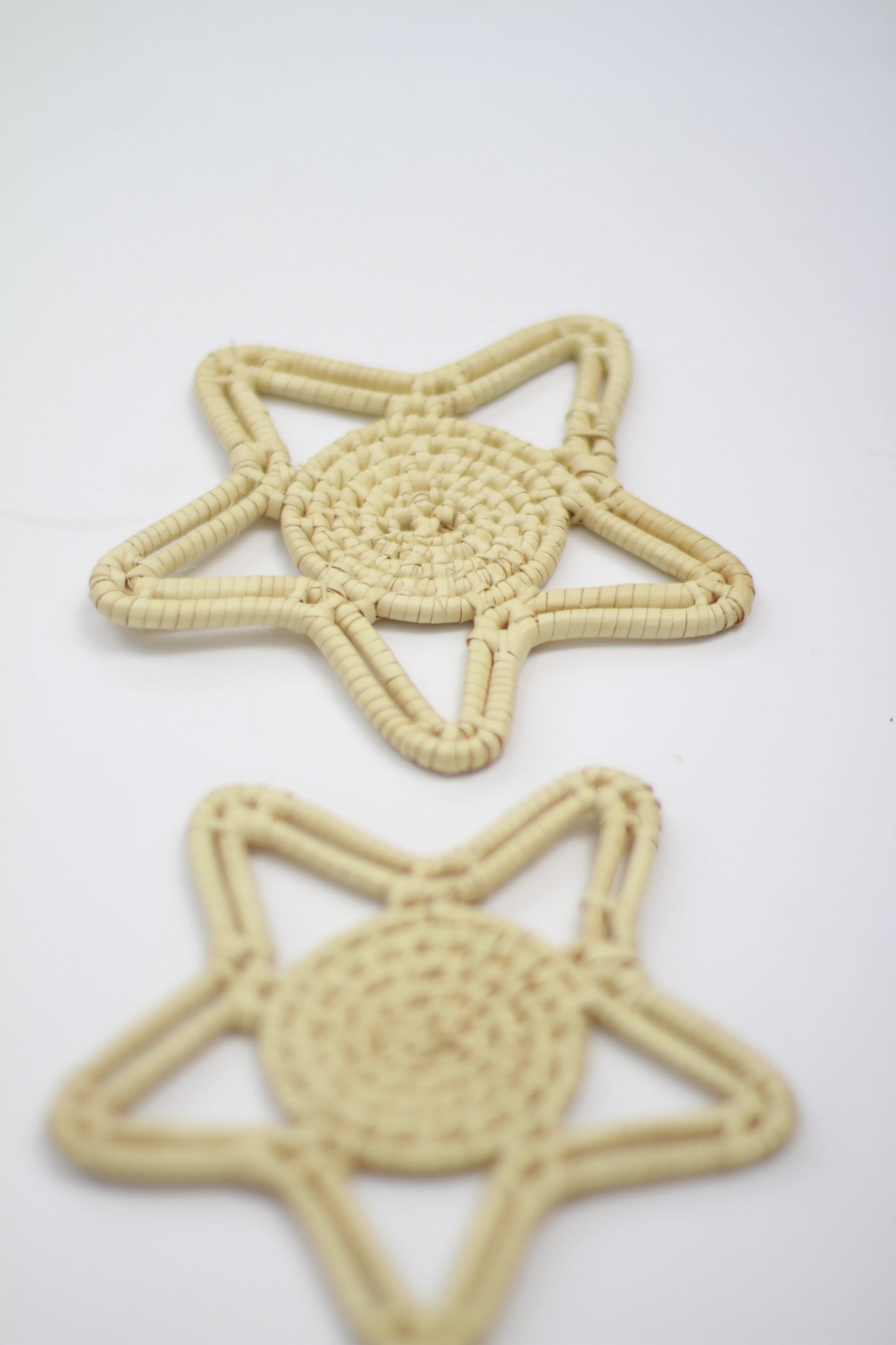 Handwoven starfish ornament made from locally sourced palm leaves and twine, eco-friendly decor.