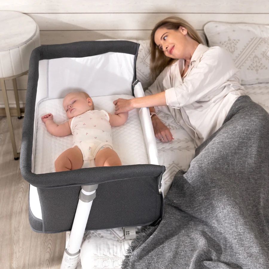 Daming bedside bassinet with lockable wheels and adjustable height, co-sleeping feature, and premium safety design.