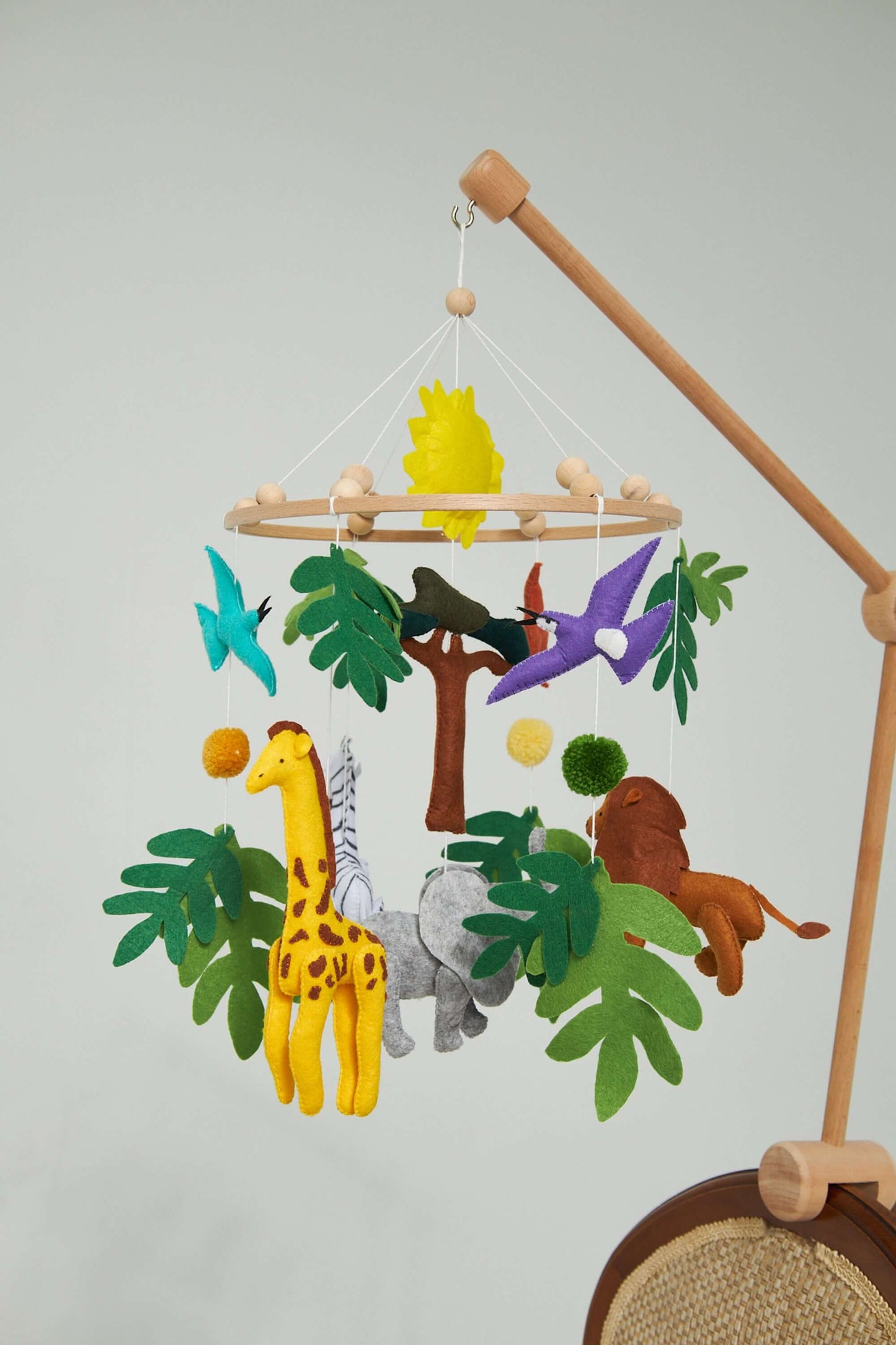 Montessori baby mobile with handmade felt animals and wooden frame for nursery decor and baby development