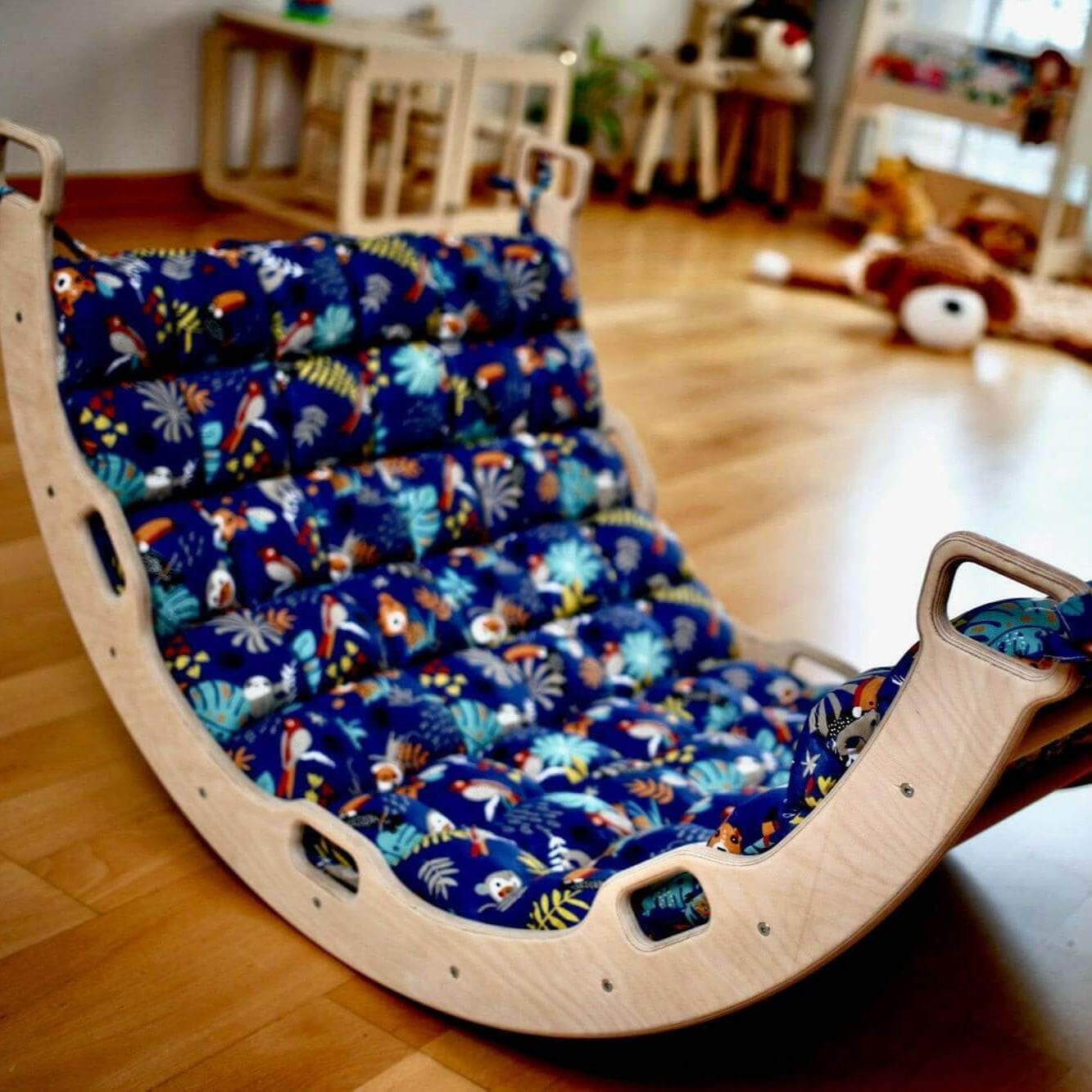 Montessori Climber Set with natural wooden arch and colorful padded toddler pillow on hardwood floor in playroom