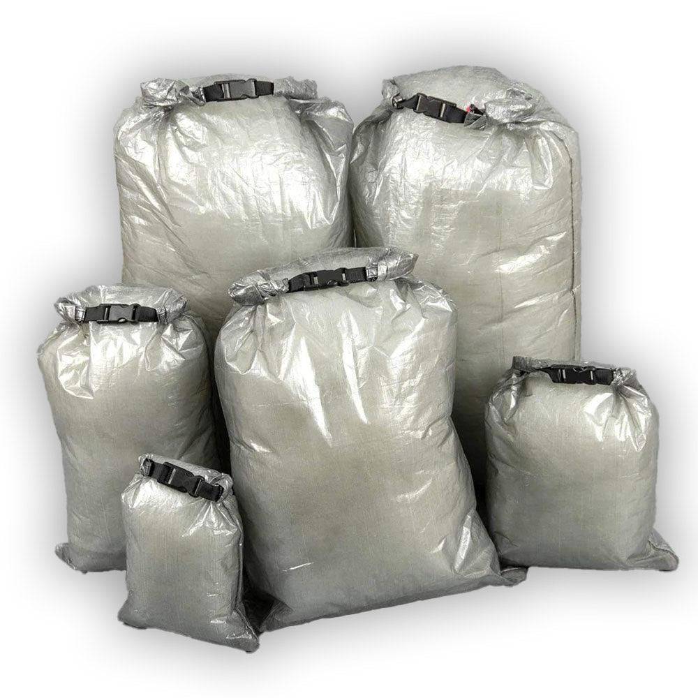 Set of six ultralight roll top dry bags made of durable Dyneema fabric in various sizes for outdoor and backpacking use
