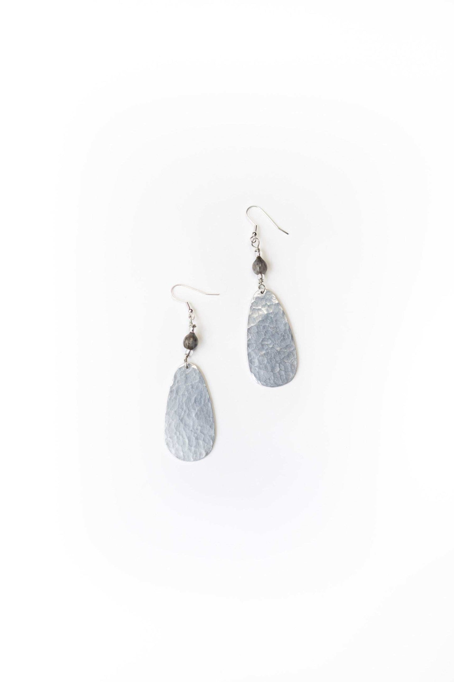 Ellipse hammered aluminum earrings with majok seed beads and silver-plated brass hooks