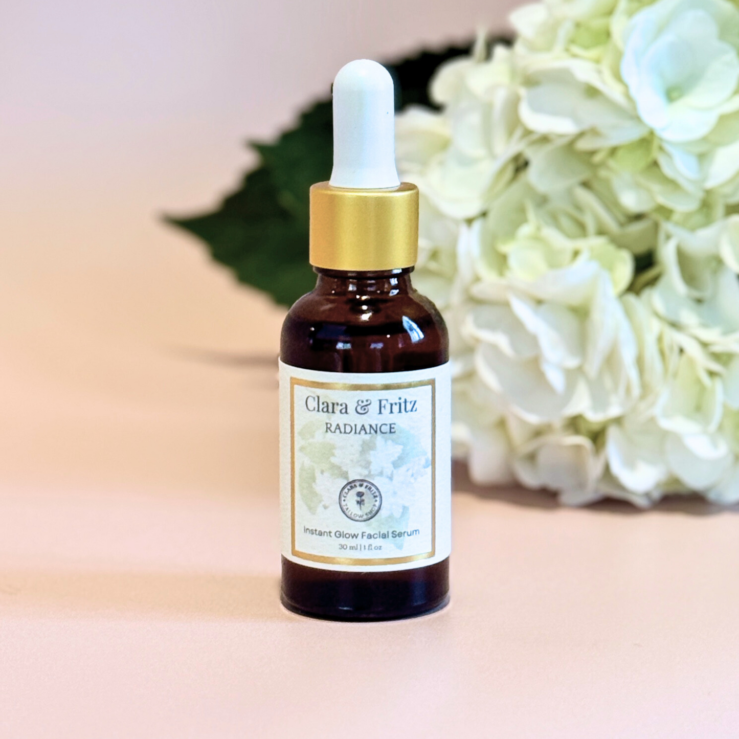 Radiance Instant Glow Facial Serum bottle with dropper and white flowers background