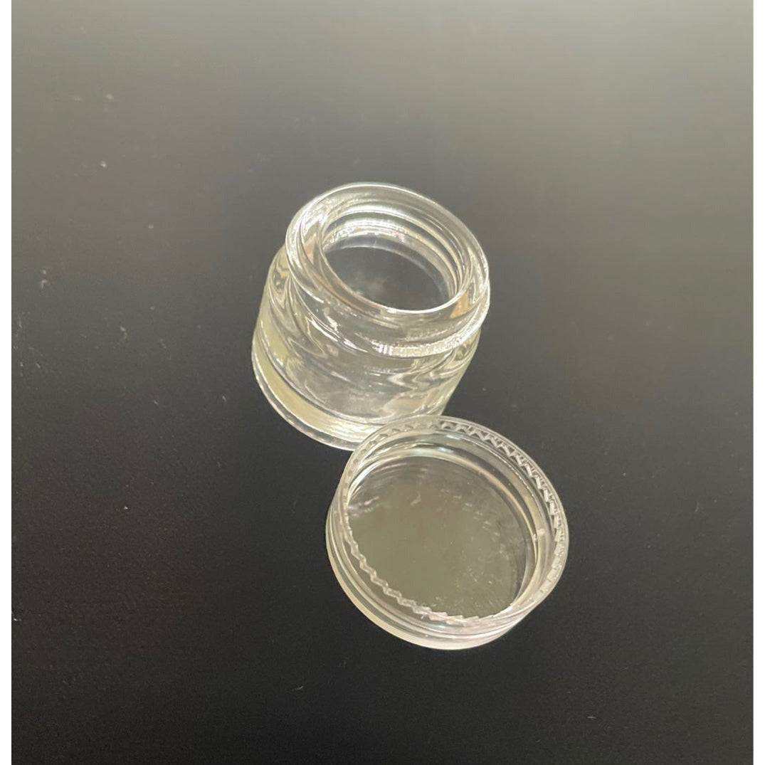5mL clear glass jar with screw top lid for cosmetics and oils.