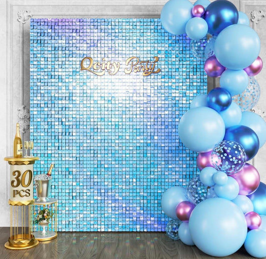 Rainbow Blue Shimmer sequin wall backdrop with 30 panels, square glitter design, black opaque back, styled with blue and purple balloons for parties and events.