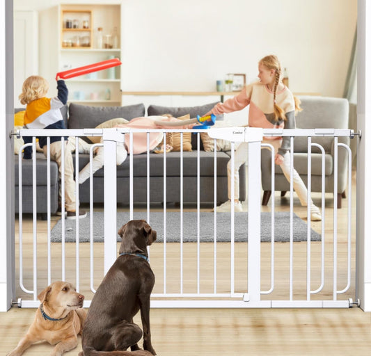 Cumbor 29.7-57" extra wide white metal baby gate installed in home with two children playing behind and two dogs in front.