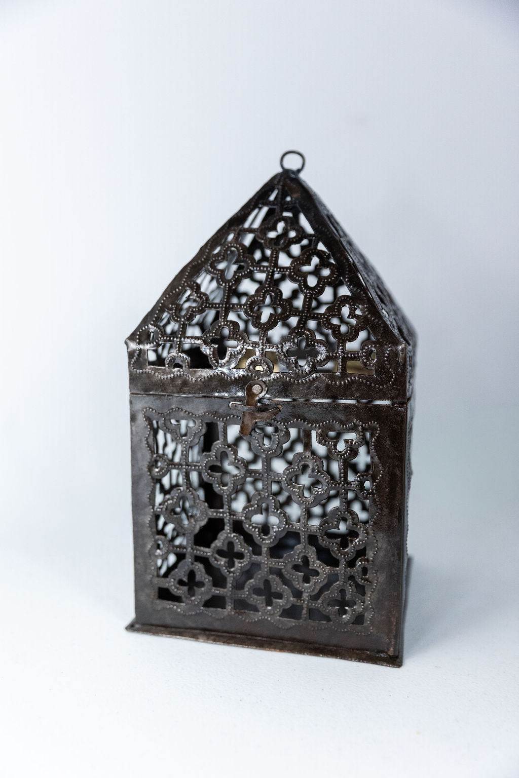 Handmade recycled metal lantern with intricate cut-out patterns and a hinged door for candles or lights