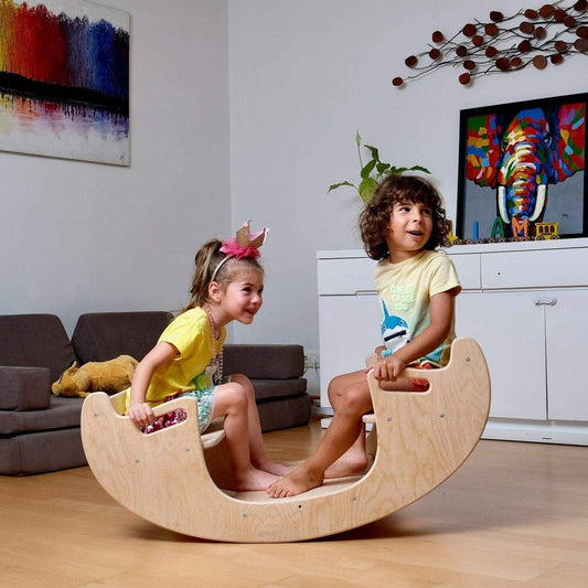 Children playing on a 2in1 Montessori wooden seesaw and chair set in a living room.