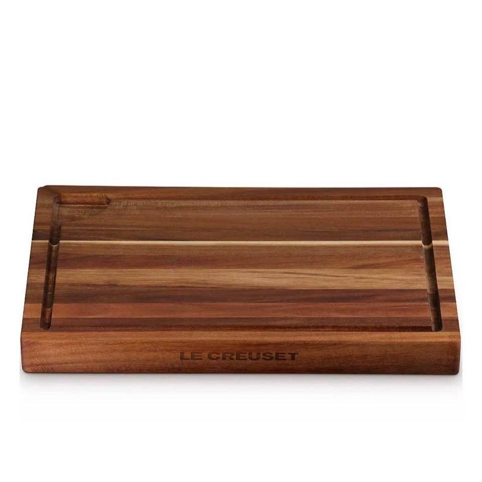 Le Creuset Acacia Wood Butcher's Block 20x14 inches with indented rim for cutting and serving.