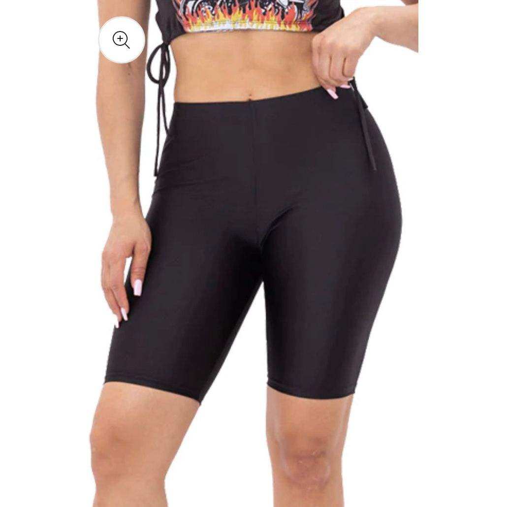 Woman wearing black nylon biker shorts modeling slim fit athletic wear