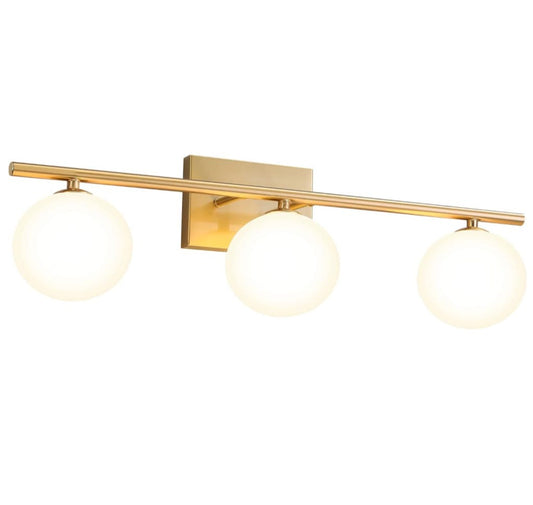 Gold bathroom vanity light fixtures with three brass milk white globe lights.
