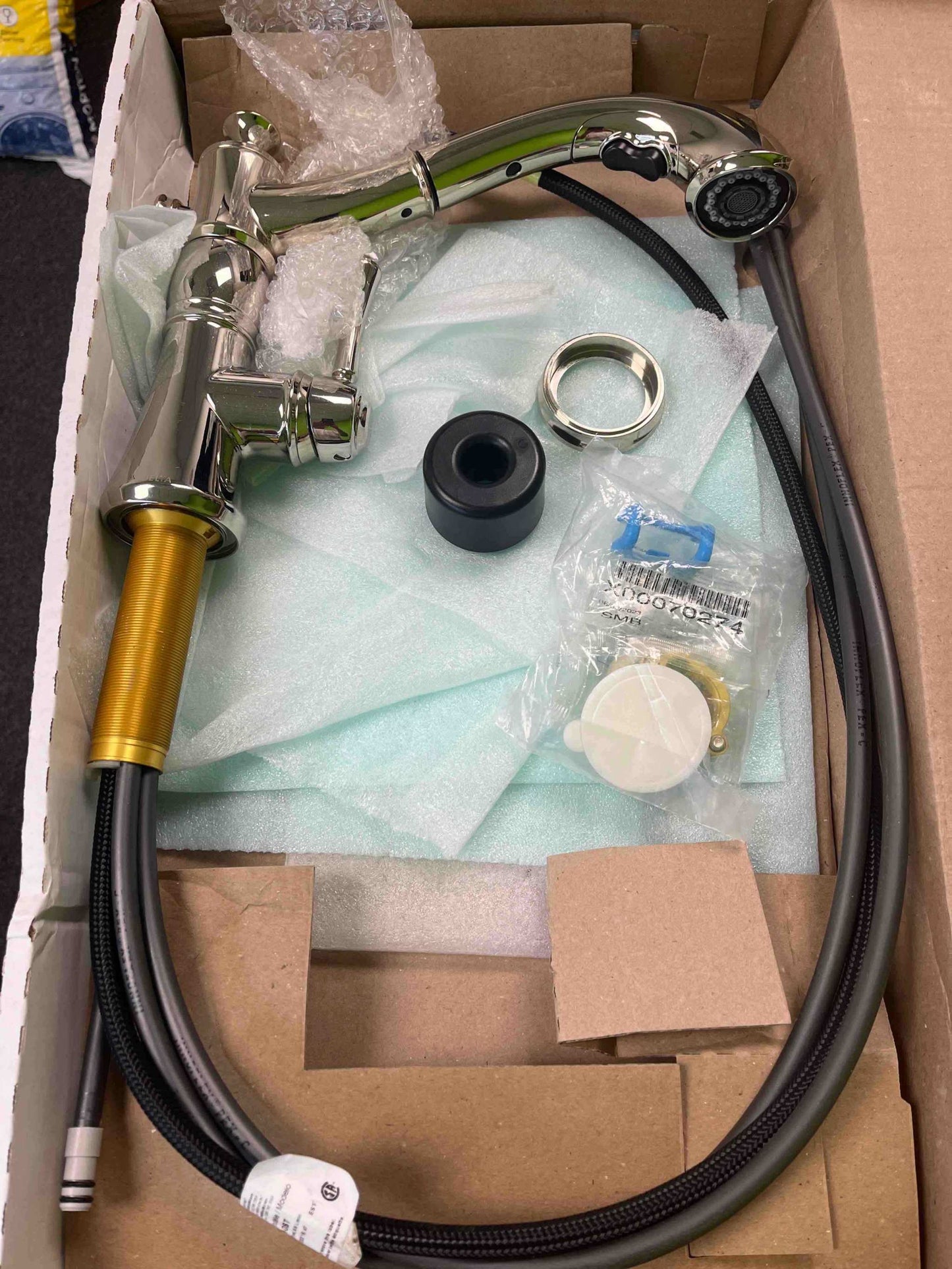 Delta 4197 PN DST Cassidy single handle pull out faucet with polished nickel finish in open box with assembly hardware.