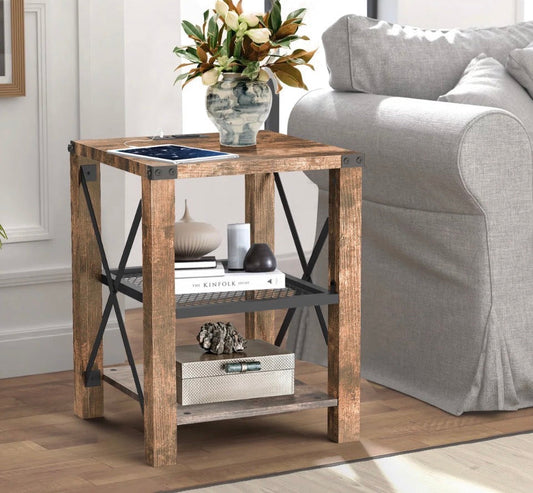 Eidelweiss Tall End Table with wood finish, metal frame, two USB ports, power outlets, and three storage shelves next to a gray sofa