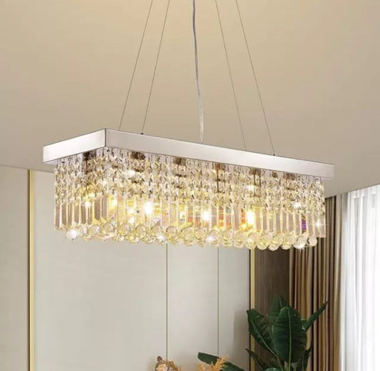 Modern 7PM Rectangle K9 Crystal Chandelier with chrome frame and hanging crystal prisms lighting dining room or kitchen island