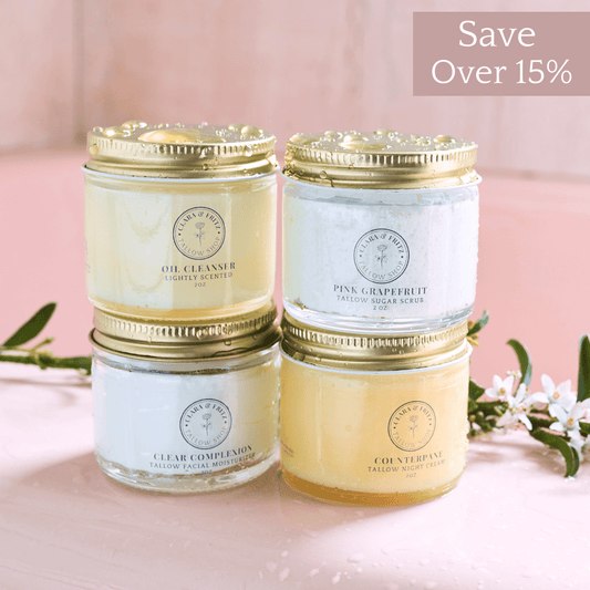 Capsule Skincare Kit with four tallow-based facial products including Oil Cleanser, Pink Grapefruit Sugar Scrub, Clear Complexion Moisturizer, and Counterpane Night Cream in glass jars with gold lids.