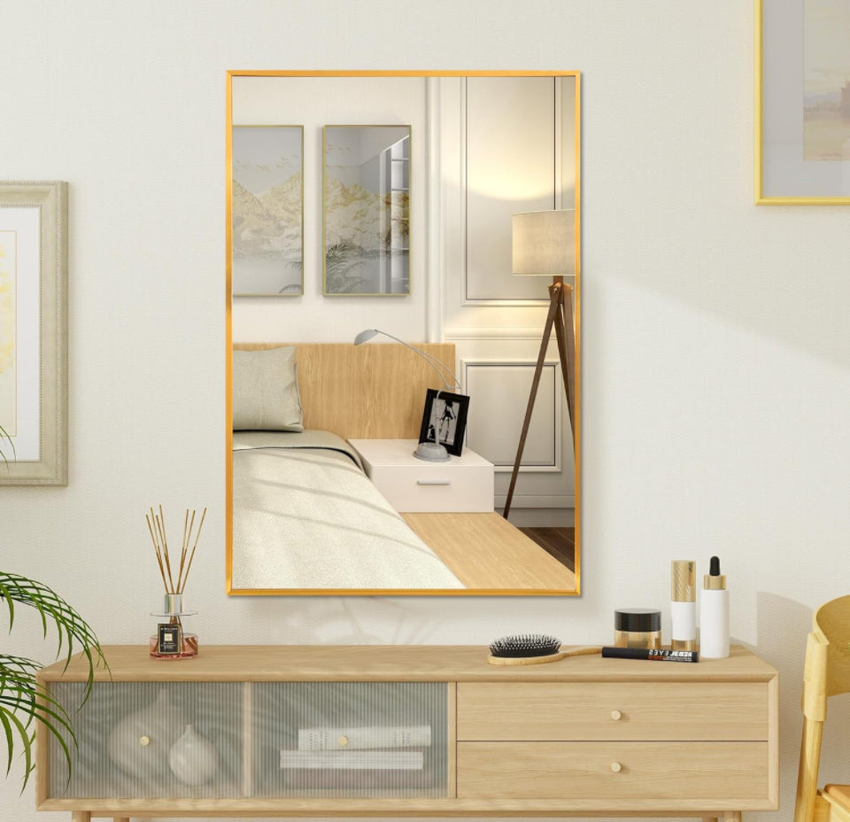 FANYUSHOW Rectangular Wall Mirror with Gold Metal Frame in modern room setting.