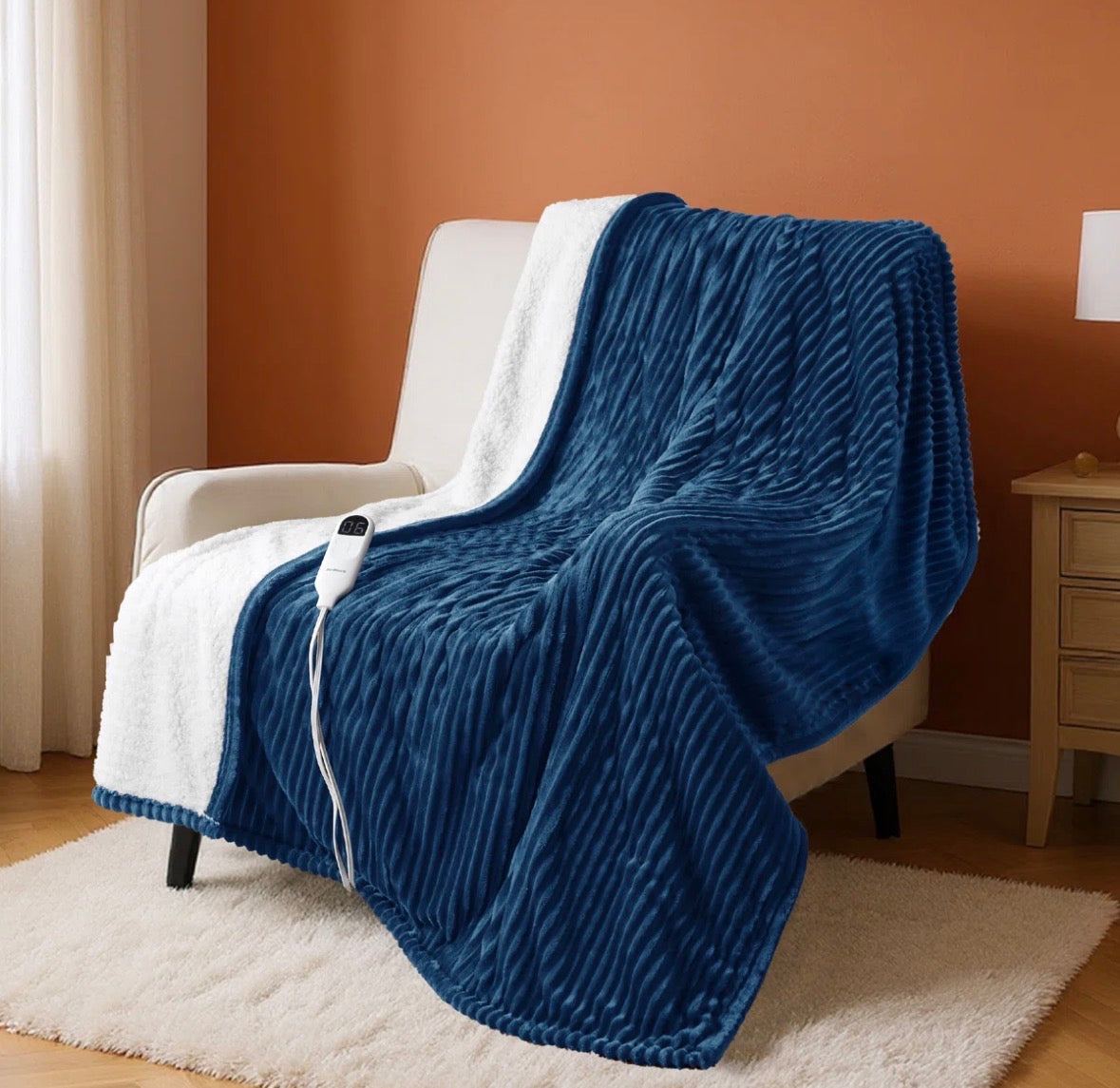 BEDSURE electric blanket soft ribbed flannel blue with white lining on chair with remote control