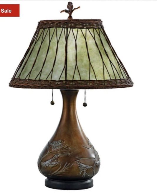 Quoizel Two Light Table Lamp with soft green mica shade and bronzed base with pine branch motif