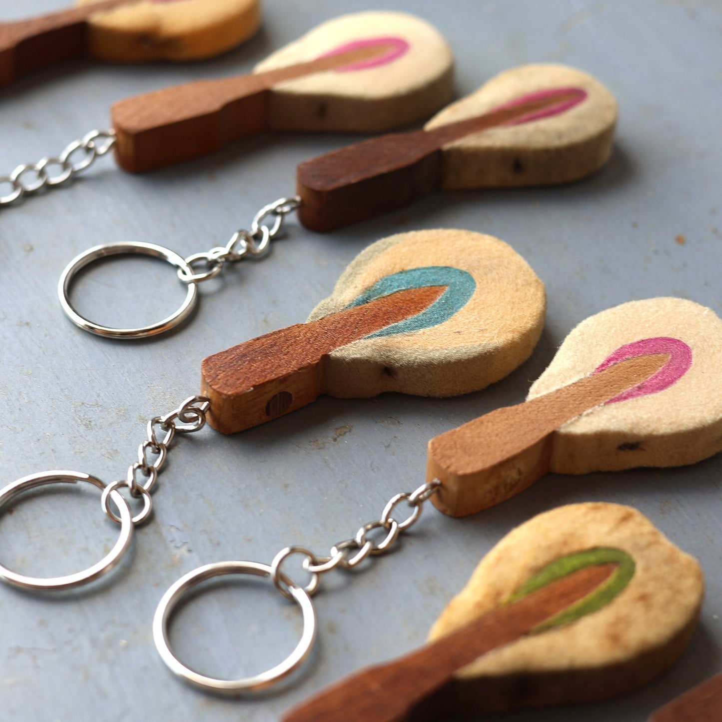 Reclaimed piano hammer keychains handmade from vintage piano hammers with colorful felt and wooden details attached to metal keyrings.