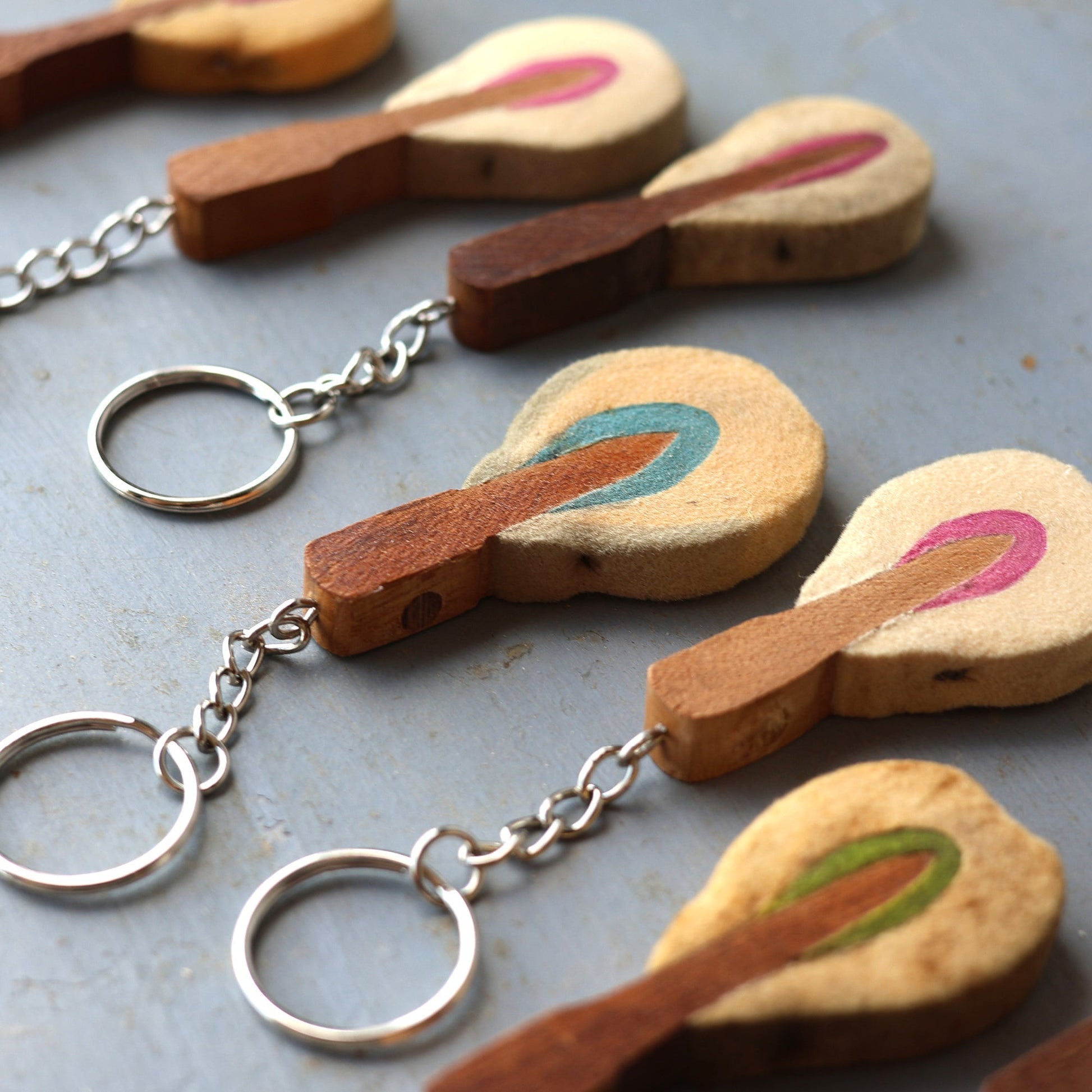 Reclaimed piano hammer keychains handmade from vintage piano hammers with colorful felt and wooden details attached to metal keyrings.