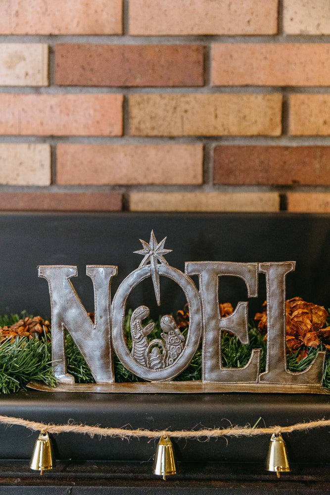 NOEL Standing Art made from upcycled steel featuring a Nativity scene with star, 18-inch arched decoration for mantel.