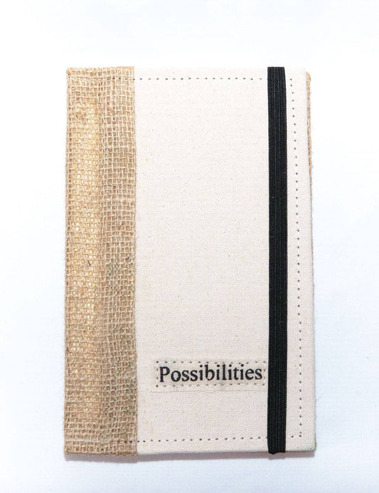 Eco-friendly fabric story journal with "Possibilities" label and black elastic band closure