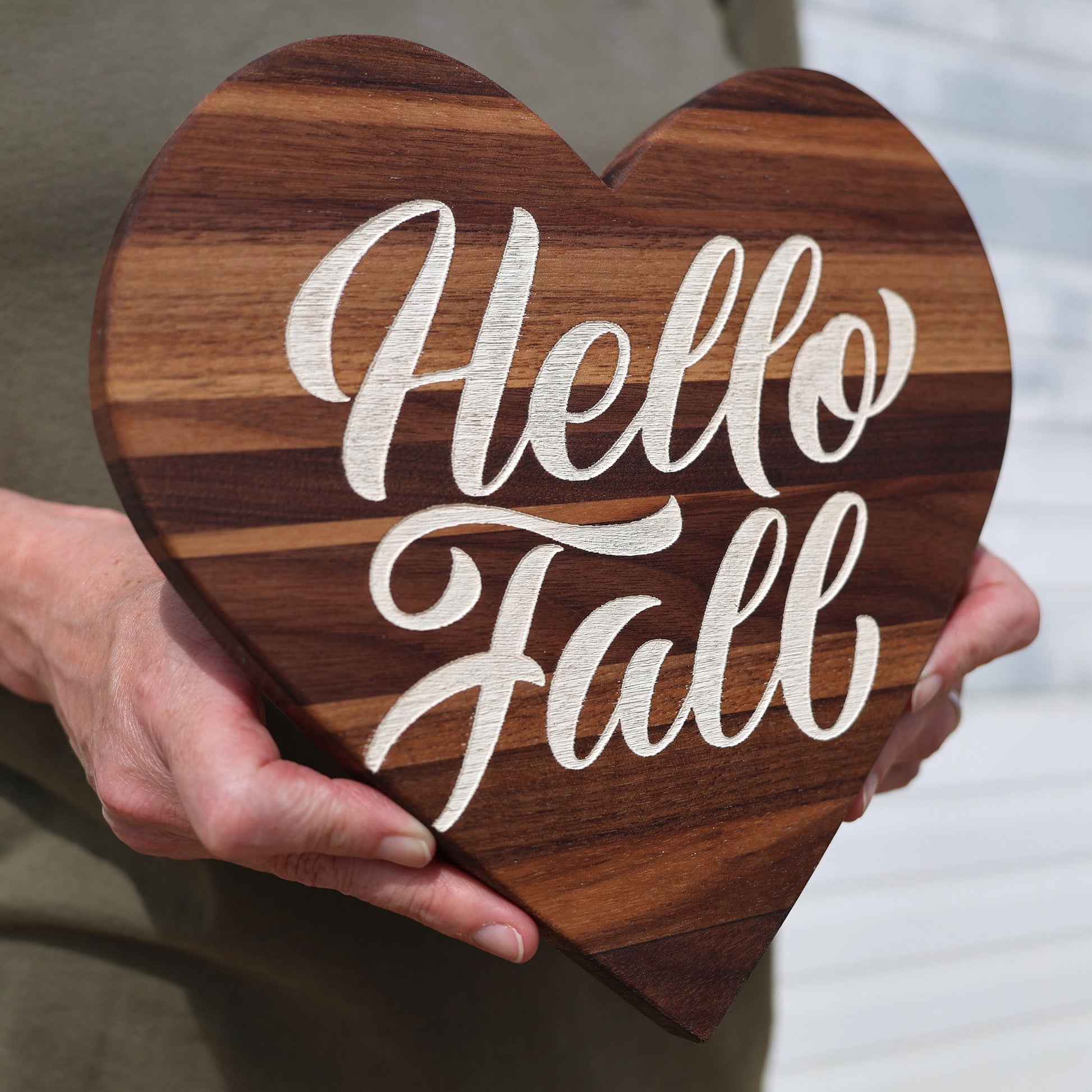 Handmade walnut heart-shaped wall hanging with "Hello Fall" engraved in white script, perfect autumn decor