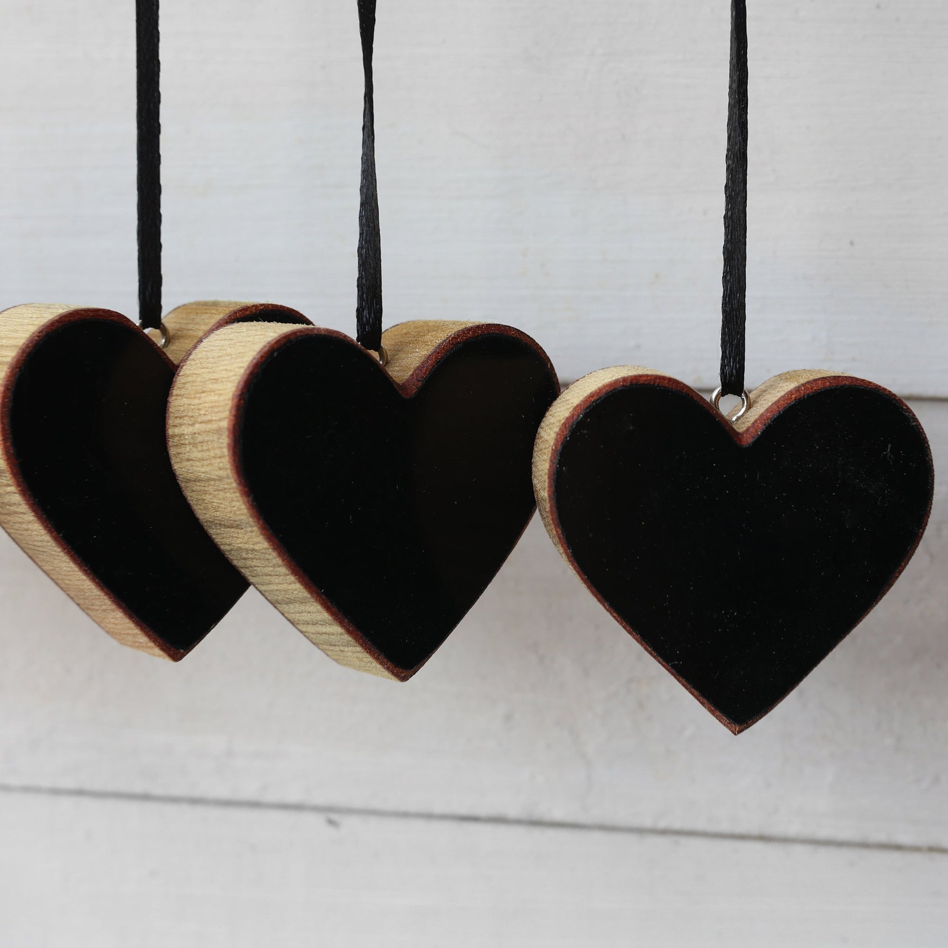 Handmade heart-shaped Steinway piano ornaments with ebony finish and black ribbon hangers made from reclaimed 1942 Steinway Grand piano wood