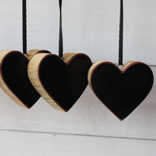 Handmade heart-shaped Steinway piano ornaments with ebony finish and black ribbon hangers made from reclaimed 1942 Steinway Grand piano wood