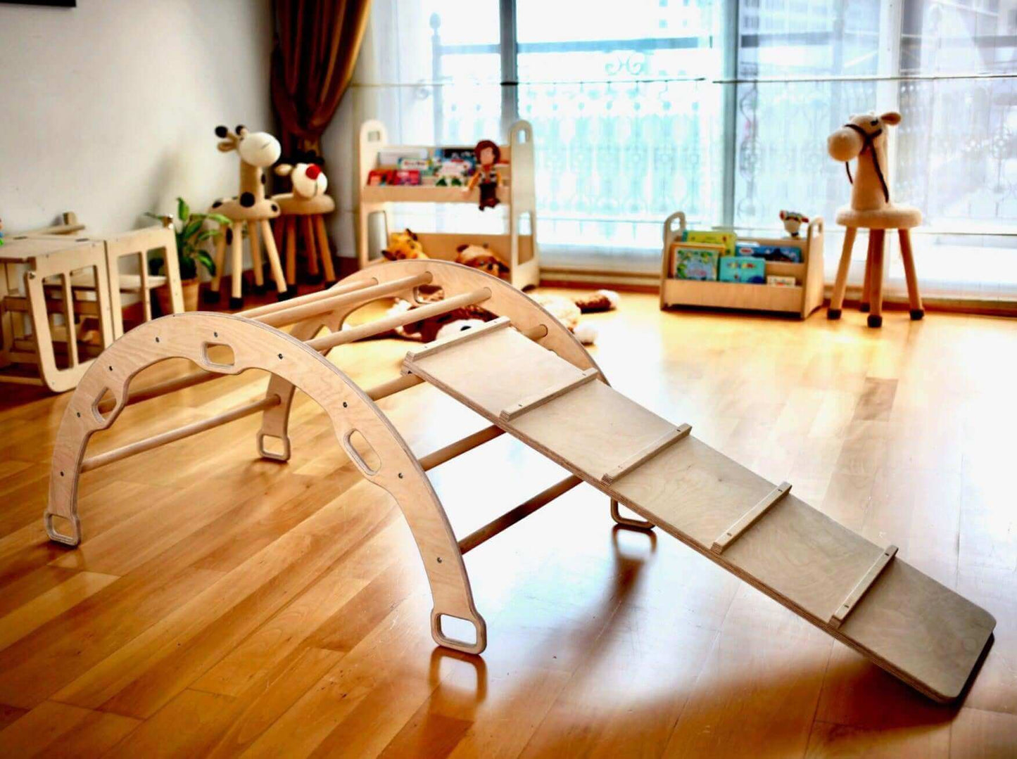 Wooden climbing arch with ladder ramp in bright playroom for toddler motor skill development