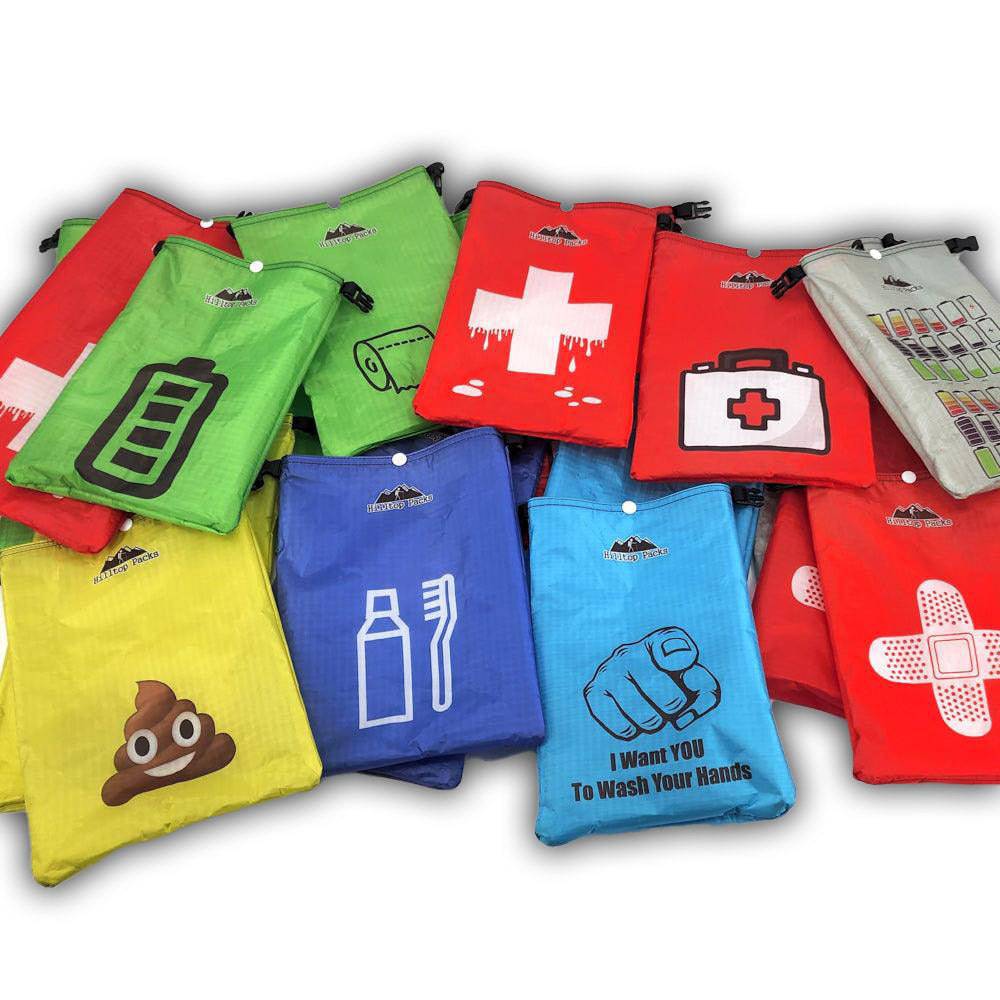 Assorted colorful printed dry bags made from ultralight waterproof fabric, featuring various fun and functional designs for organizing gear outdoors
