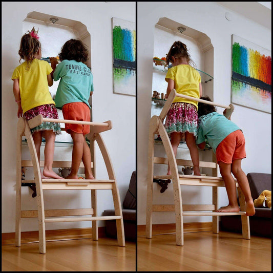 Two children using a natural wood Montessori toddler tower in a home setting for safe elevated play and learning.