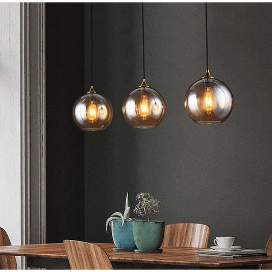 Bepuzz Plug in mid-century amber glass pendant lights over dining table.
