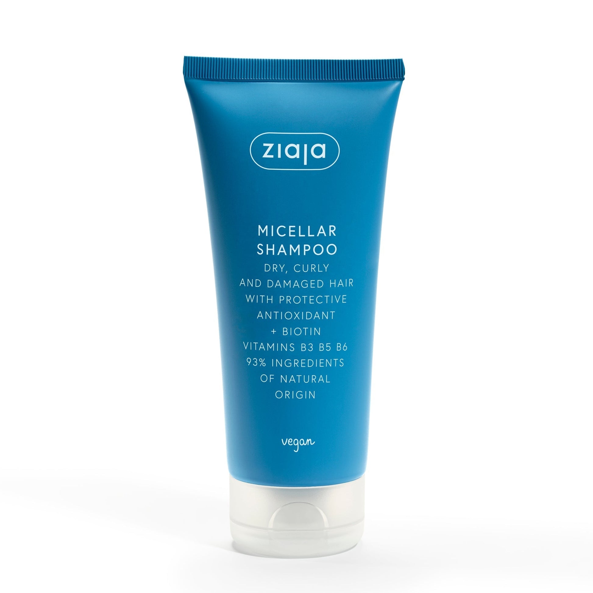 Blue tube of Ziaja Antioxidant Hair Care Micellar Shampoo for dry, curly, and damaged hair with biotin and vitamins B3, B5, B6, containing 93% natural ingredients.