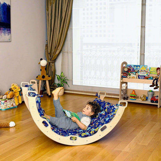 Child playing on Montessori Arch with XL Forest Design Pillow in bright playroom with wooden floor and toys