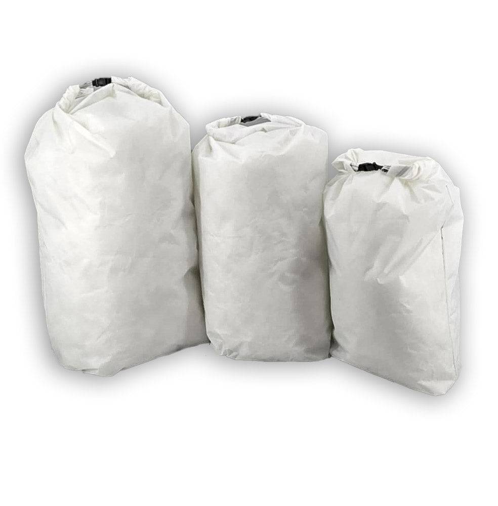 Three white ultralight waterproof pack liners made from Challenge D50T fabric in small, medium, and large sizes for hiking and backpacking.
