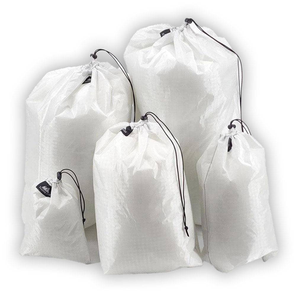Set of five white ultralight stuff sacks made from durable Challenge D50T fabric with drawstring closures for hiking and backpacking gear organization