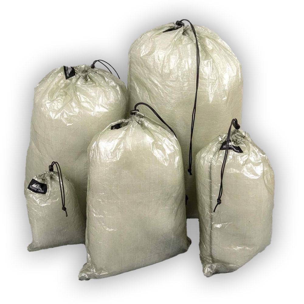 Set of five ultralight Dyneema® stuff sacks in various sizes with drawstring closures for backpacking and camping gear organization.