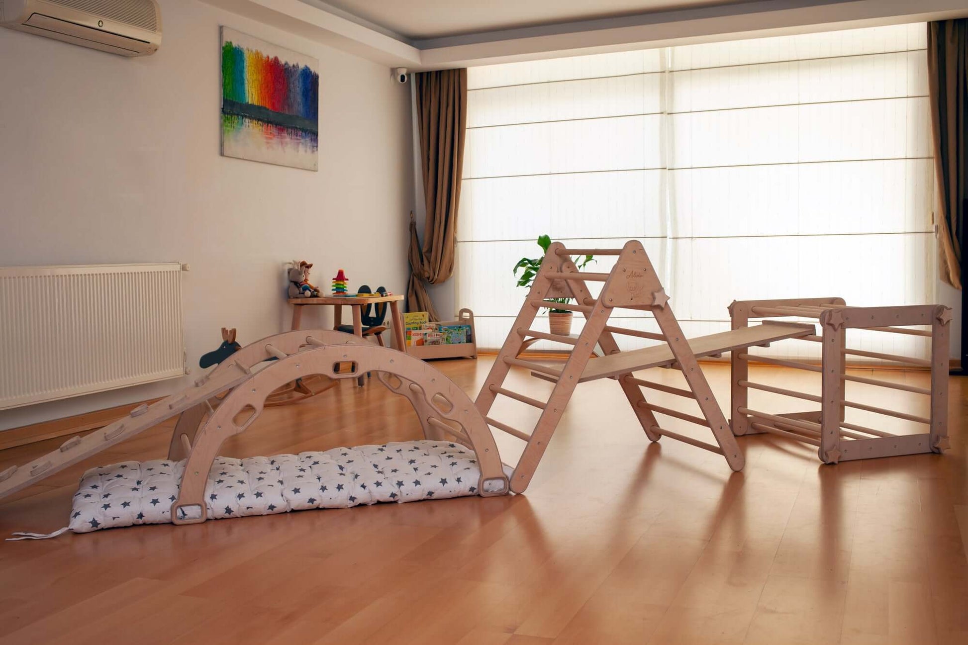 Montessori Climber Set indoor playground with 6 natural wood pieces including climbing triangle, arch, transformable cube, ramps, and cushioned pillow for child development.
