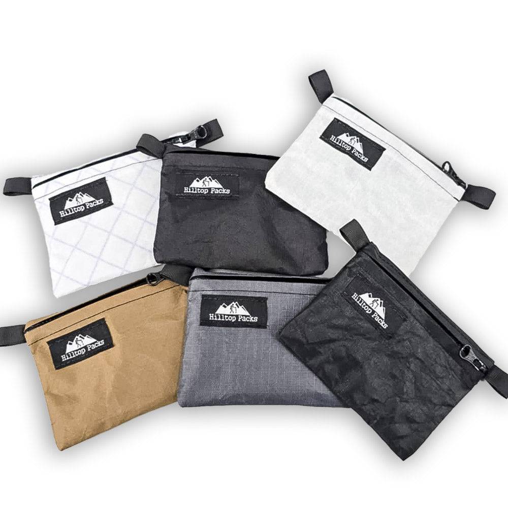 Set of six ultralight zipper wallets in various colors made with weatherproof YKK zippers and durable fabrics by Hilltop Packs