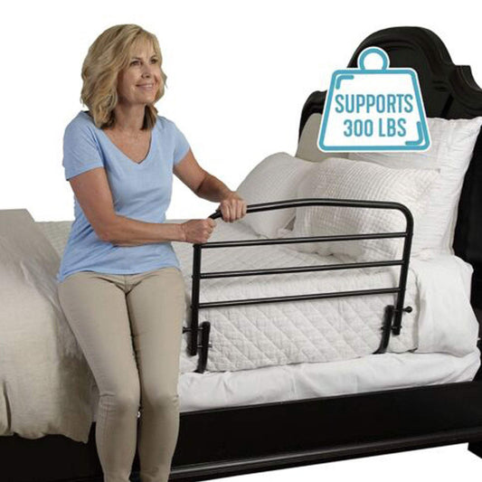 Adult woman using Stander 30-inch Safety Bed Rail with padded pouch on king-size bed supporting up to 300 lbs