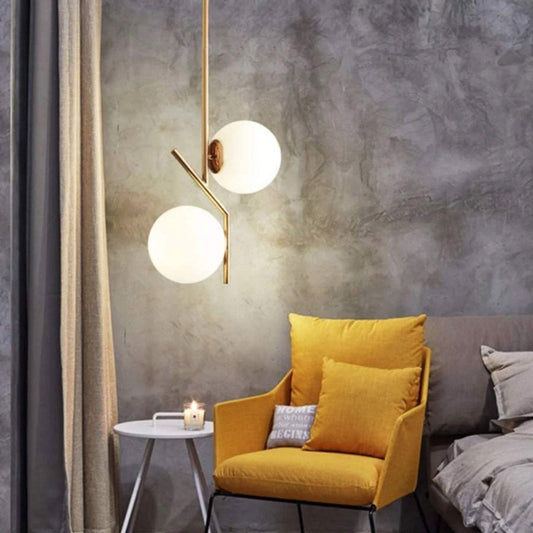 BOKT Mid Century Modern Kitchen Pendant Light with Golden Finish and White Frosted Glass Globes.