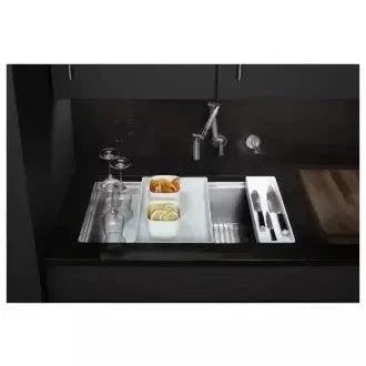 Kohler Stages 33" under-mount stainless steel sink with accessories in modern kitchen.